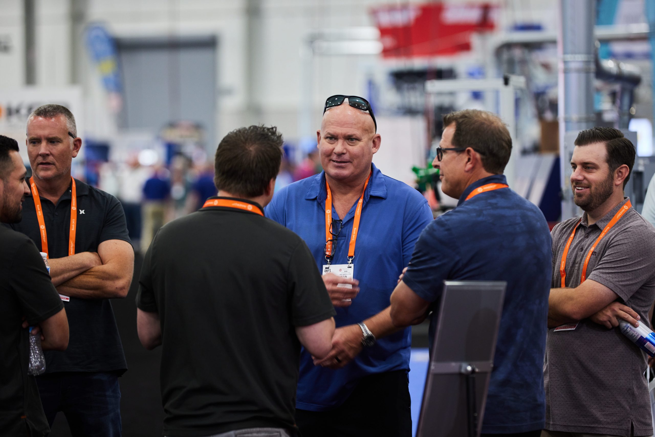 business people shaking hands at trade show